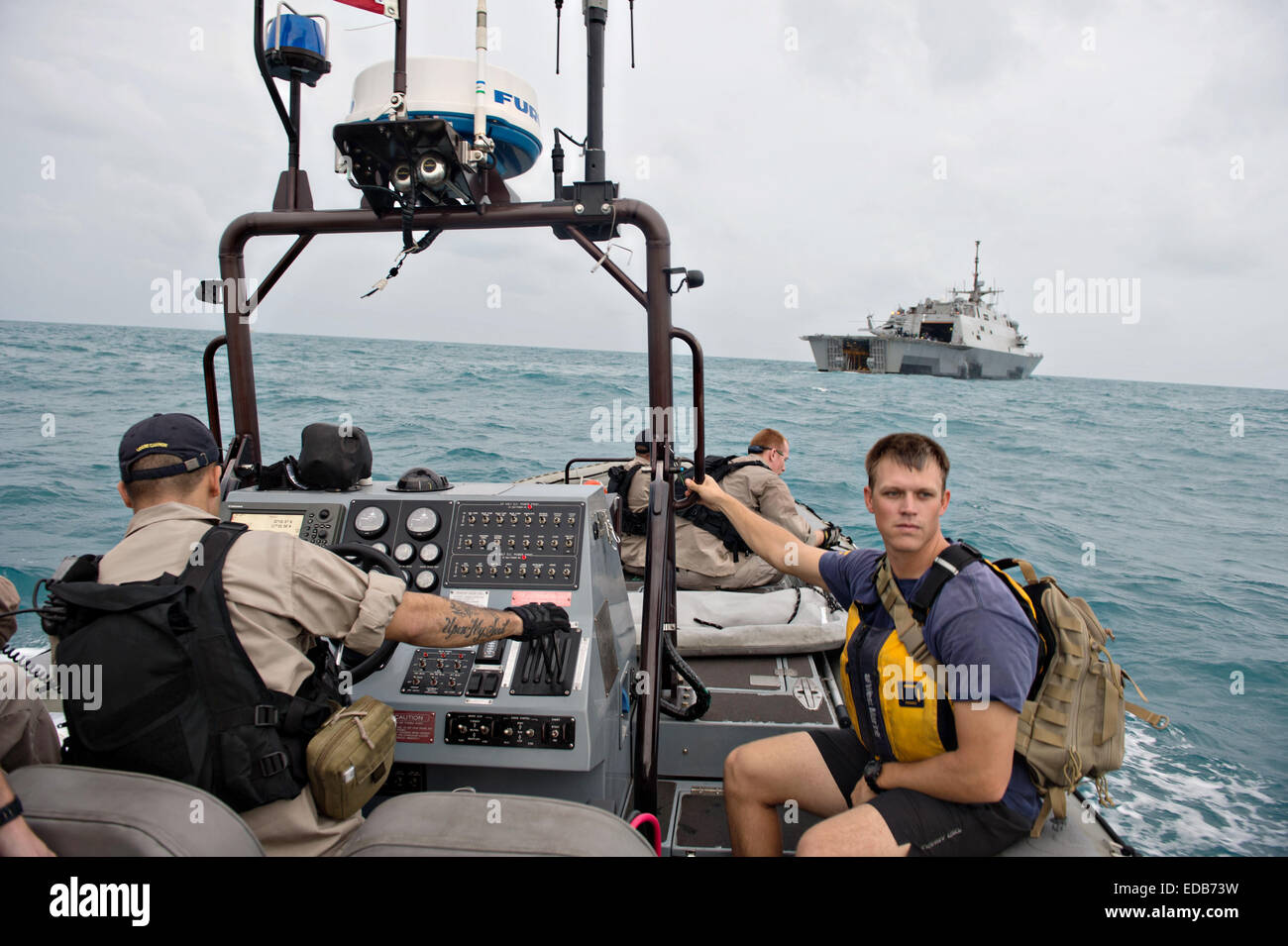 US Navy sailors from the littoral combat ship USS Fort Worth prepare to launch a Tow Fish side scan sonar system a rigid hull inflatable boat to assist in locating the missing AirAsia Flight QZ 8501 January 4, 2015 in the Java Sea. Stock Photo