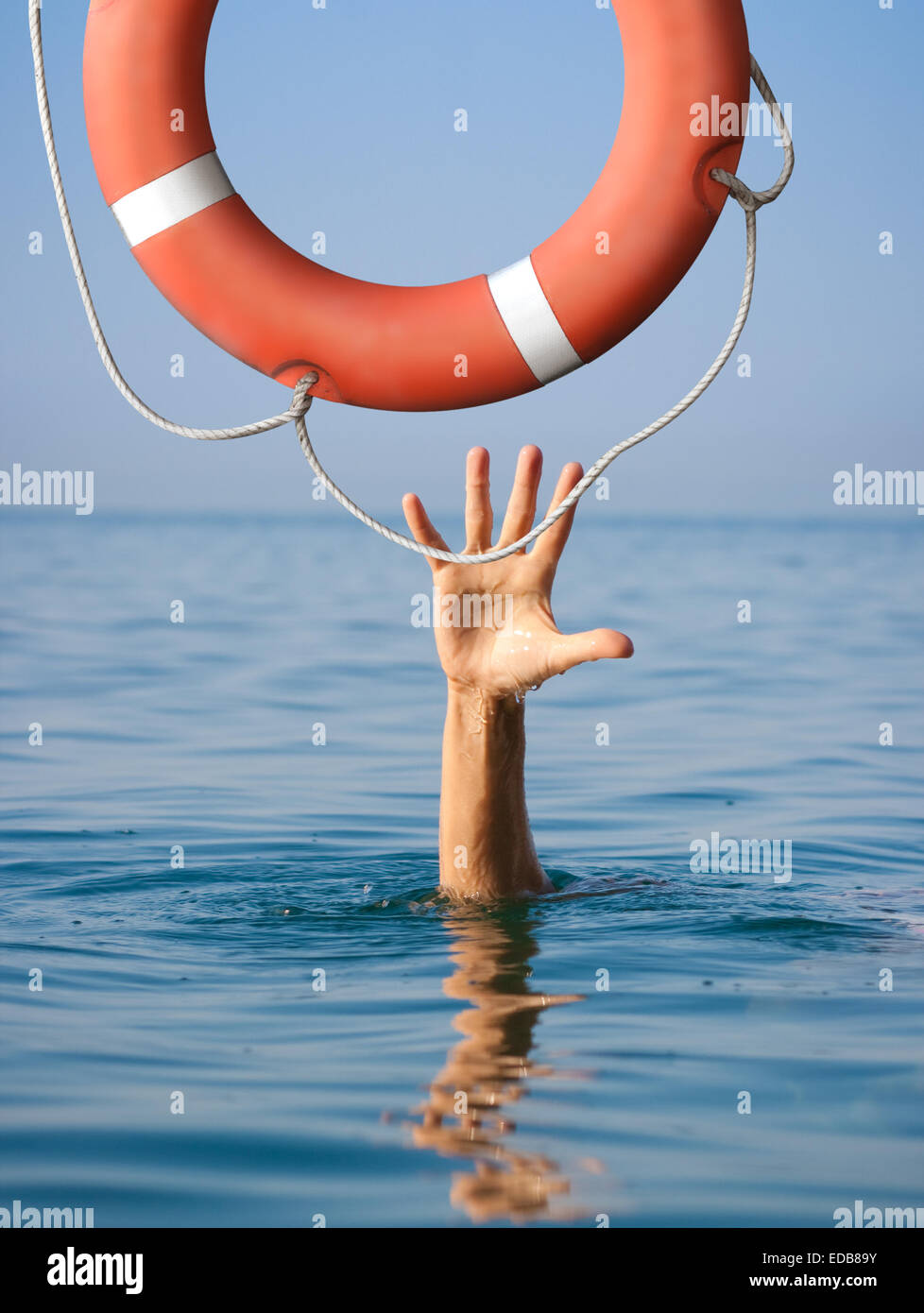 Lifebuoy for drowning man in sea or ocean water. Insurance concept. Stock Photo