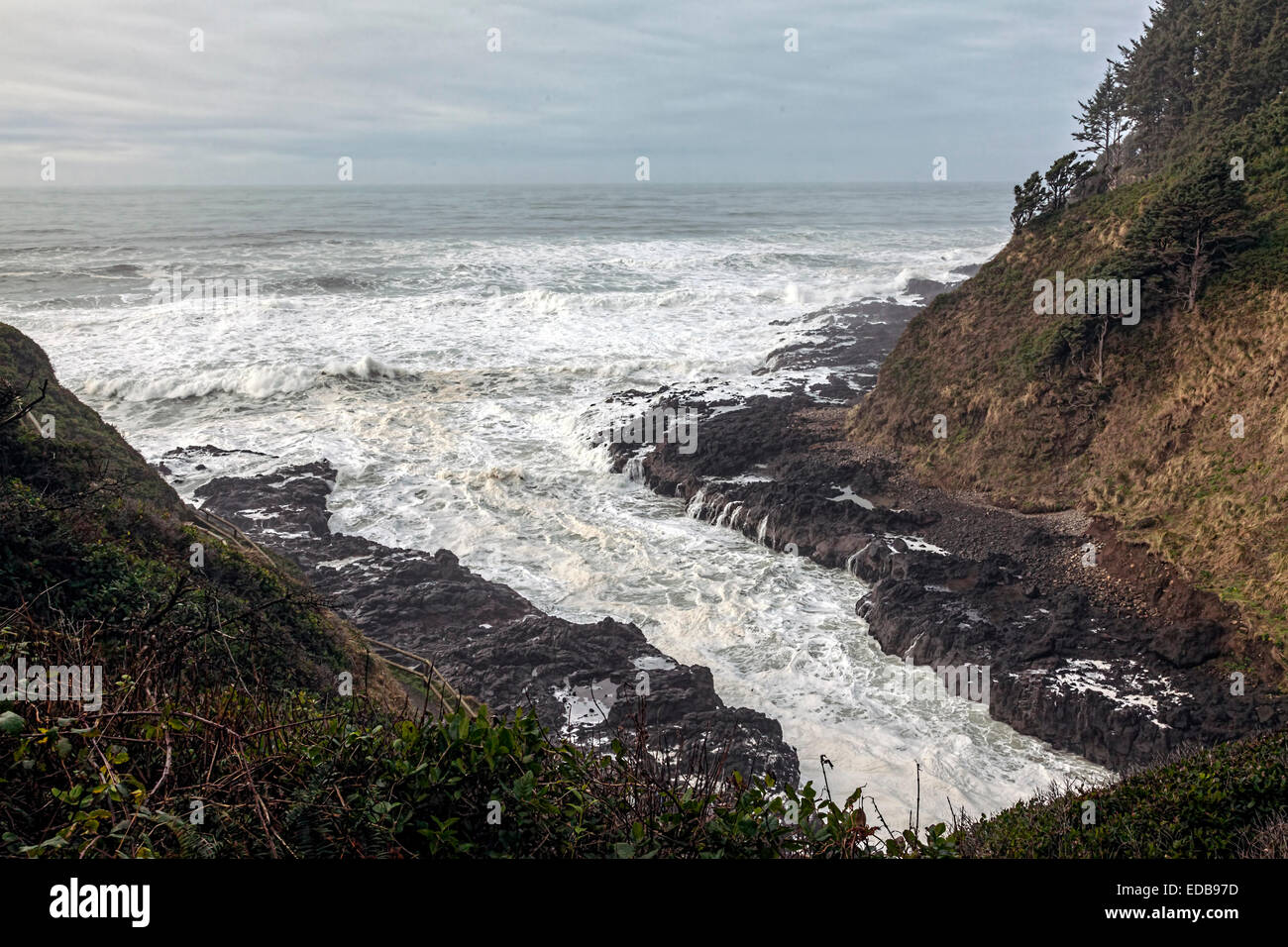 Stormy seas pound into the Devil's Churn and Cape Perpetua' coastline south of Yachats along the scenic Oregon Coast Highway. Stock Photo