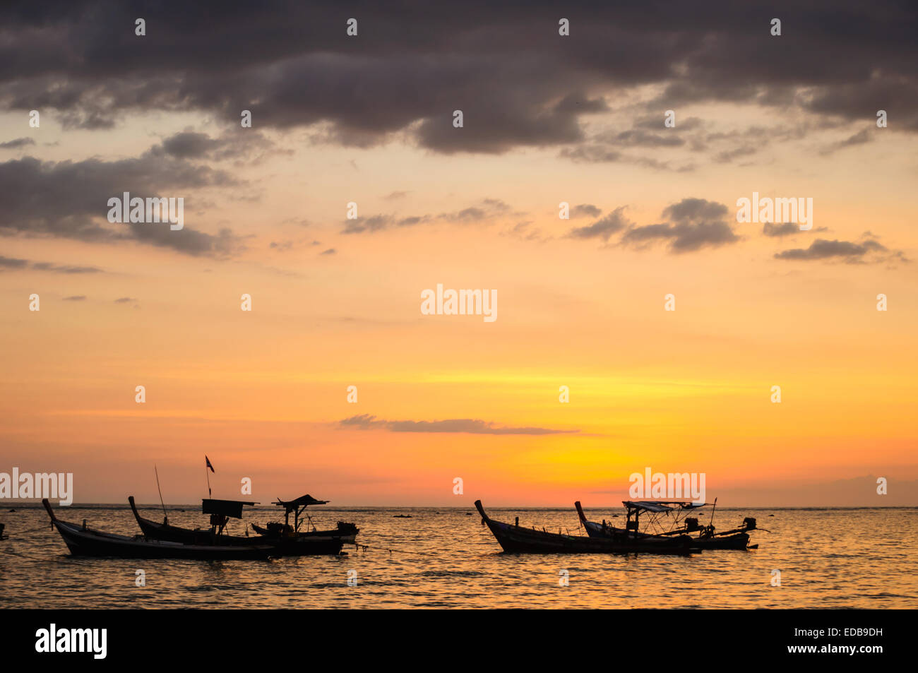 Silhouette boat at beach and sunset Stock Photo - Alamy