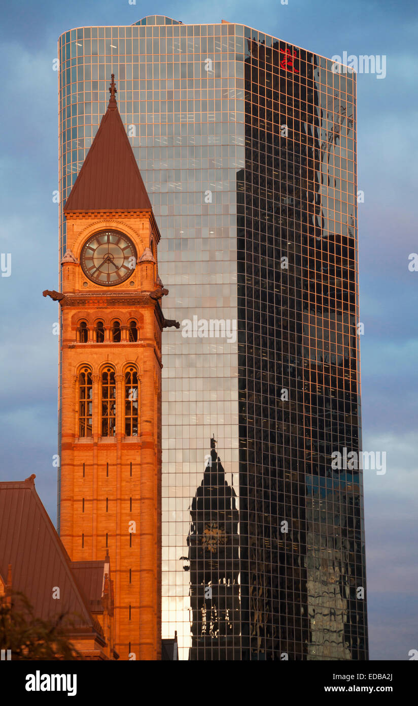 Clock tower of Toronto Old City Hall reflected on city buildings