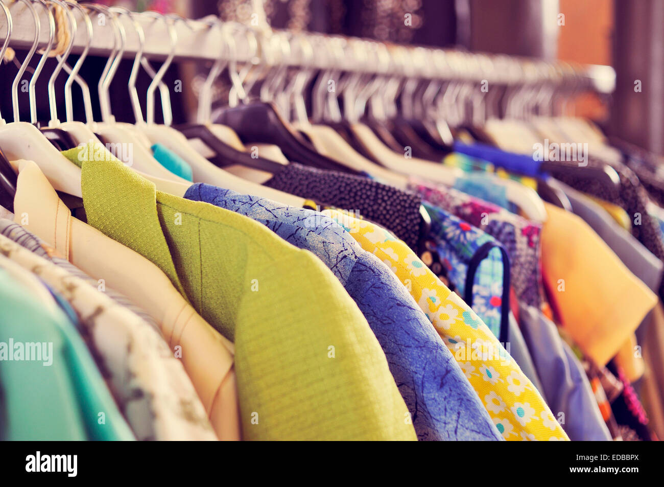 some used clothes hanging on a rack in a flea market Stock Photo Alamy