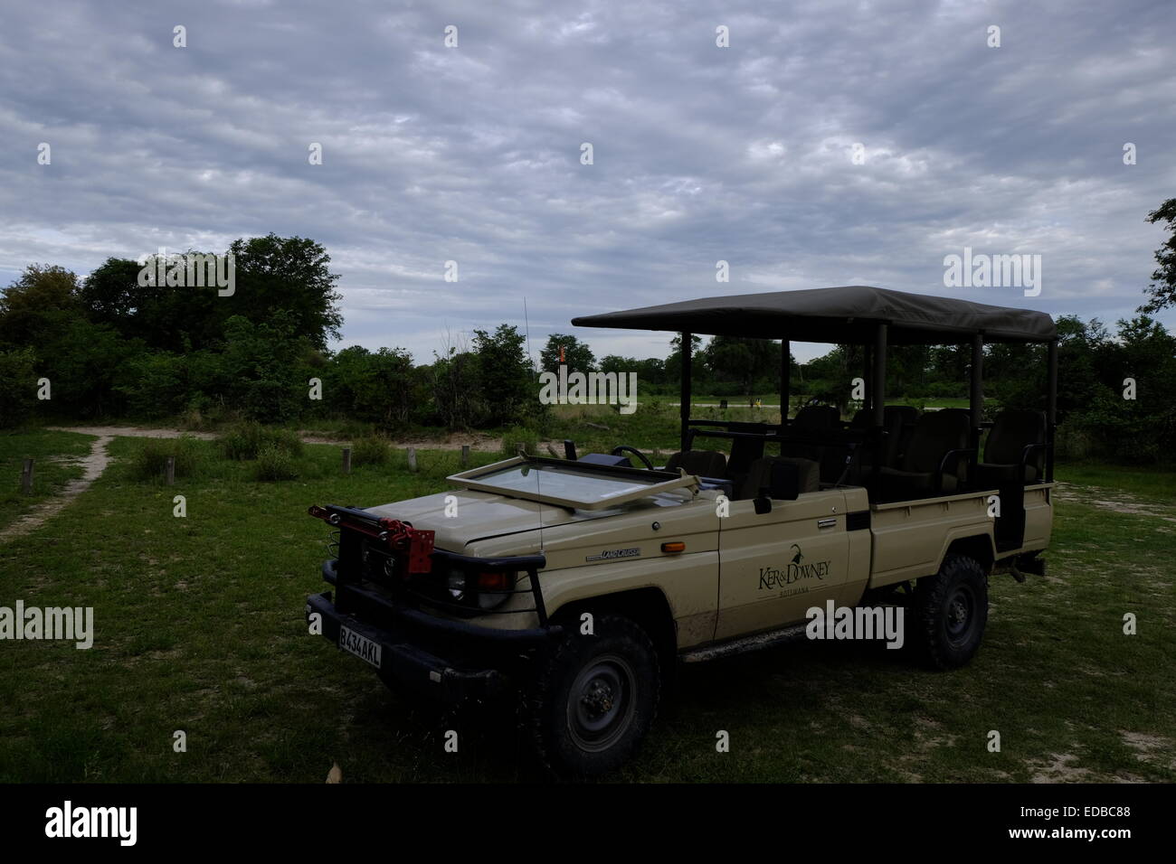 A game viewing vehicle in the late afternoon under cloudy skies Botswana Stock Photo