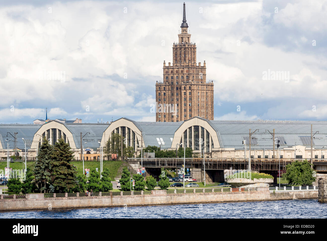 Market halls, central market, with the high rise building of the Latvian Academy of Sciences on the Daugava river or Western Stock Photo