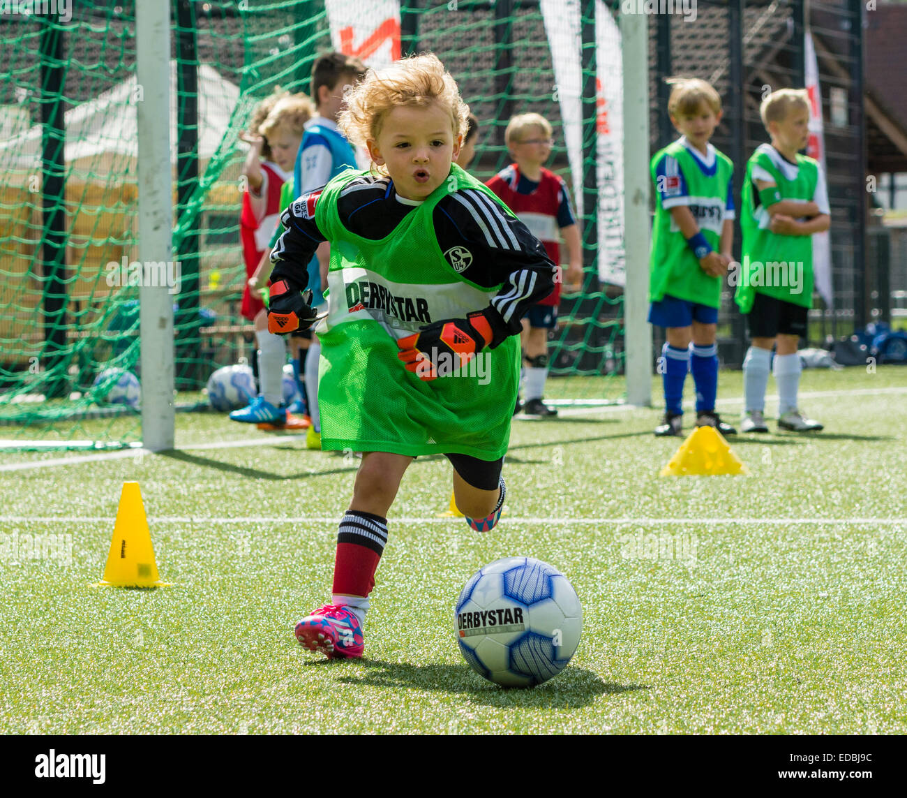 A boy plays football at a training session of a football club. Stock Photo