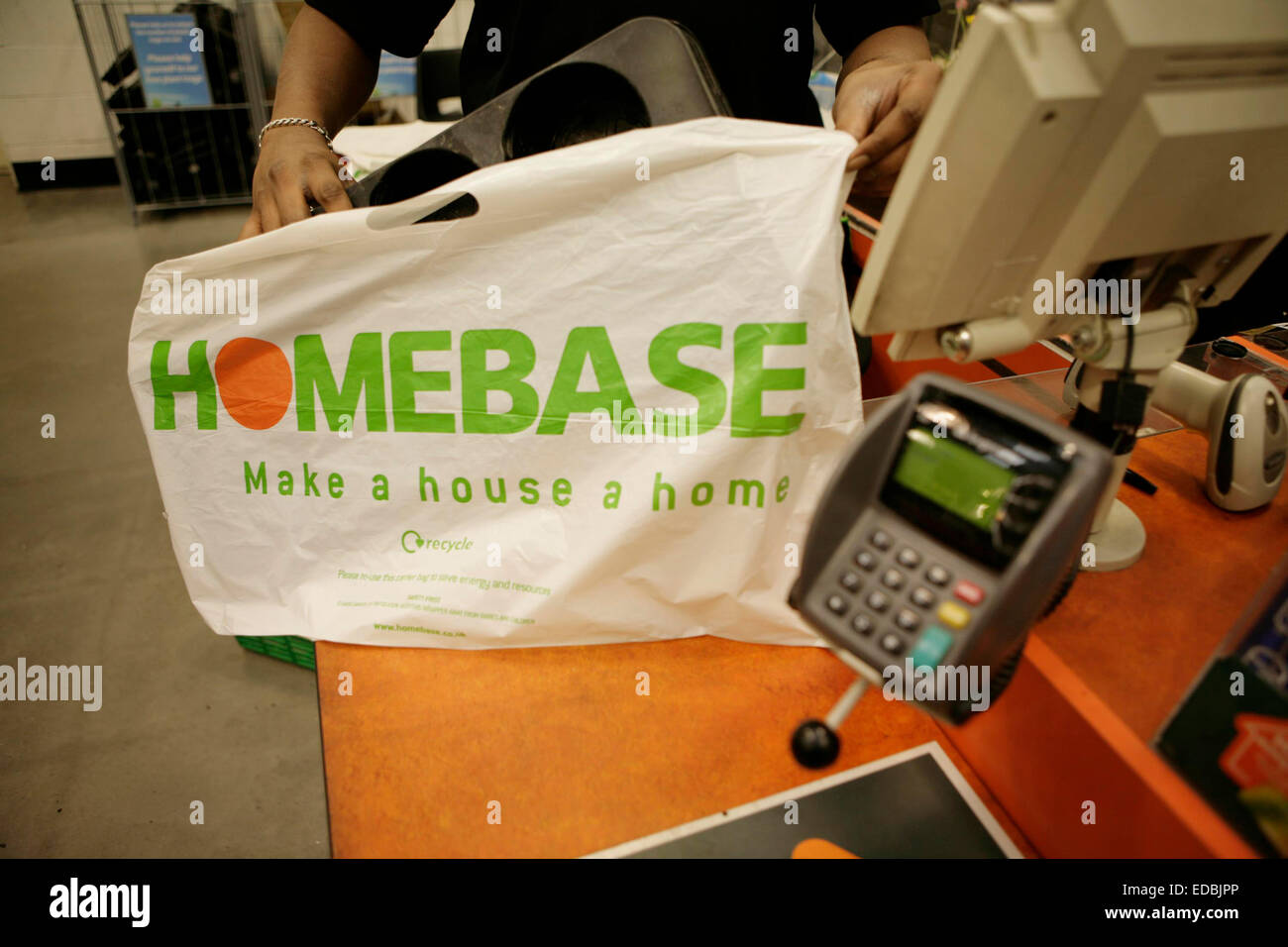 Employees working a till points in a Homebase store. Stock Photo