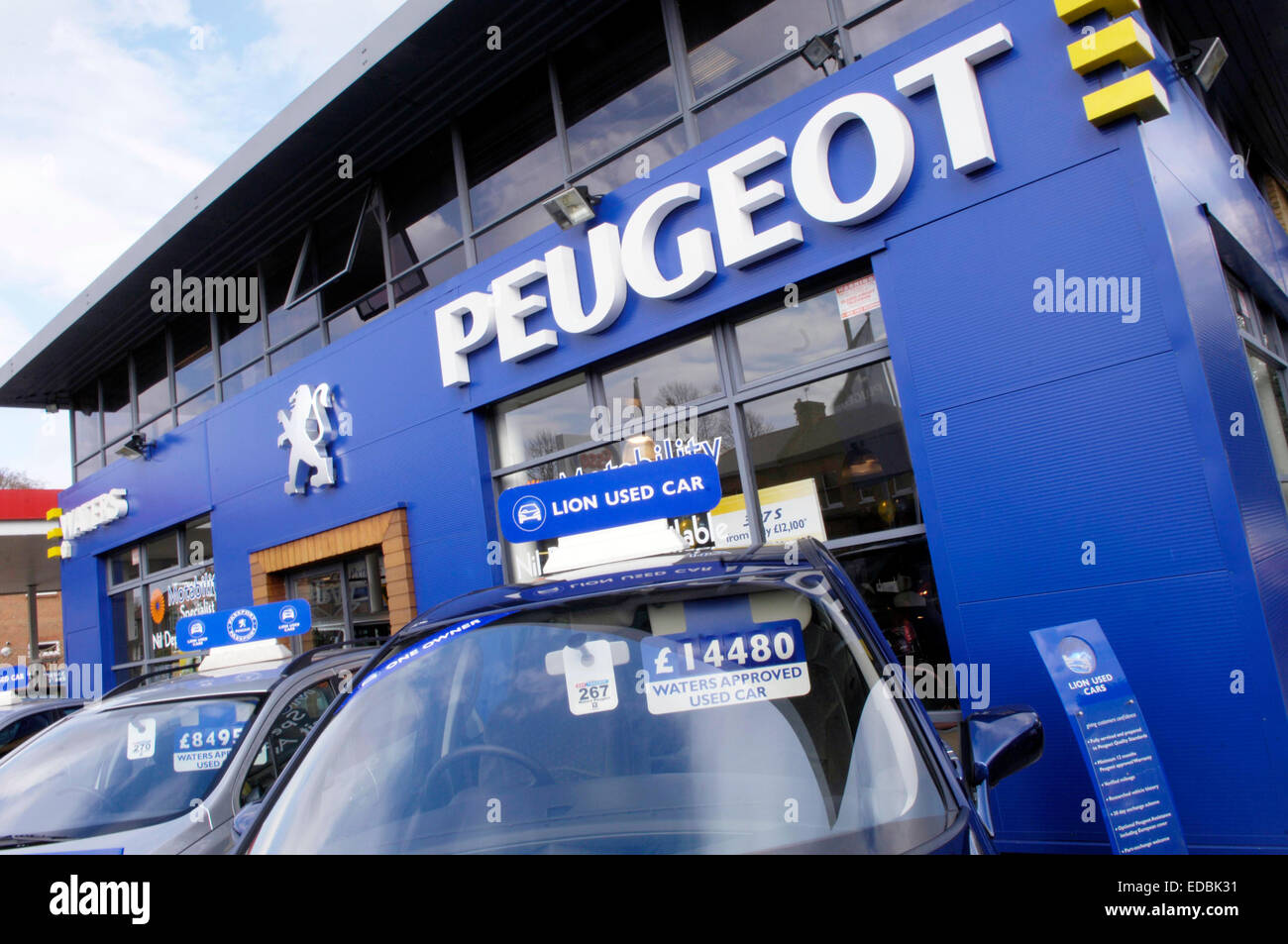 Second hand cars on display outside a Peugeot car dealership. Stock Photo