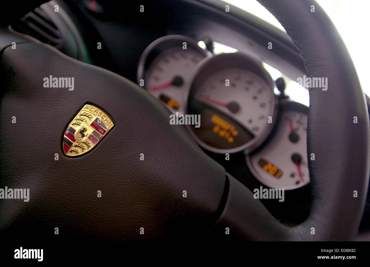 Picture shows the steering wheel and dials of a Porsche vehicle. Stock Photo