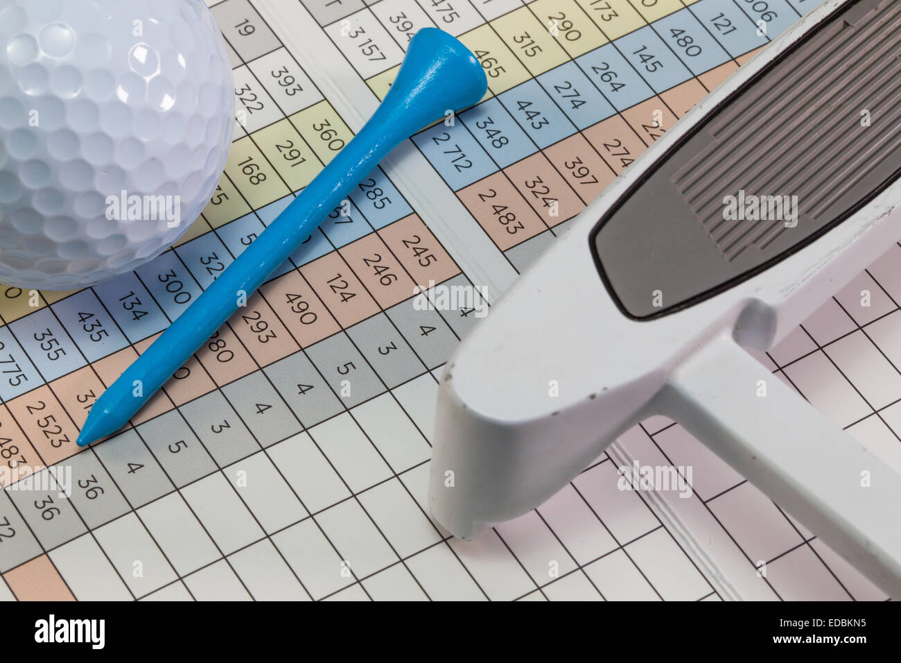 Golf putter and other equipments lying on a golf score card Stock Photo
