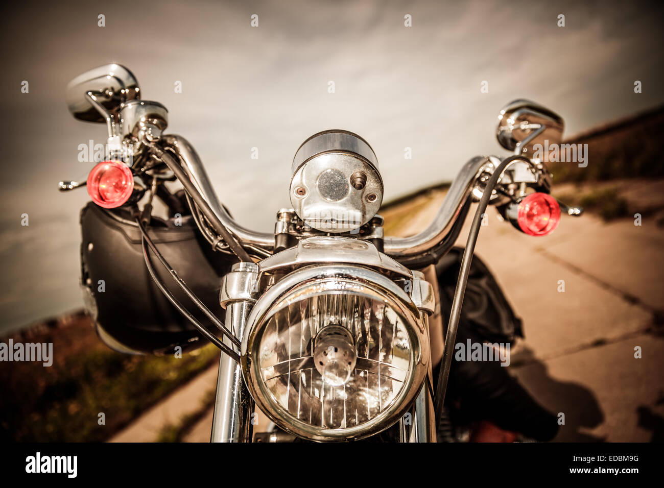 Motorcycle on the road with a helmet on the handlebars. Stock Photo