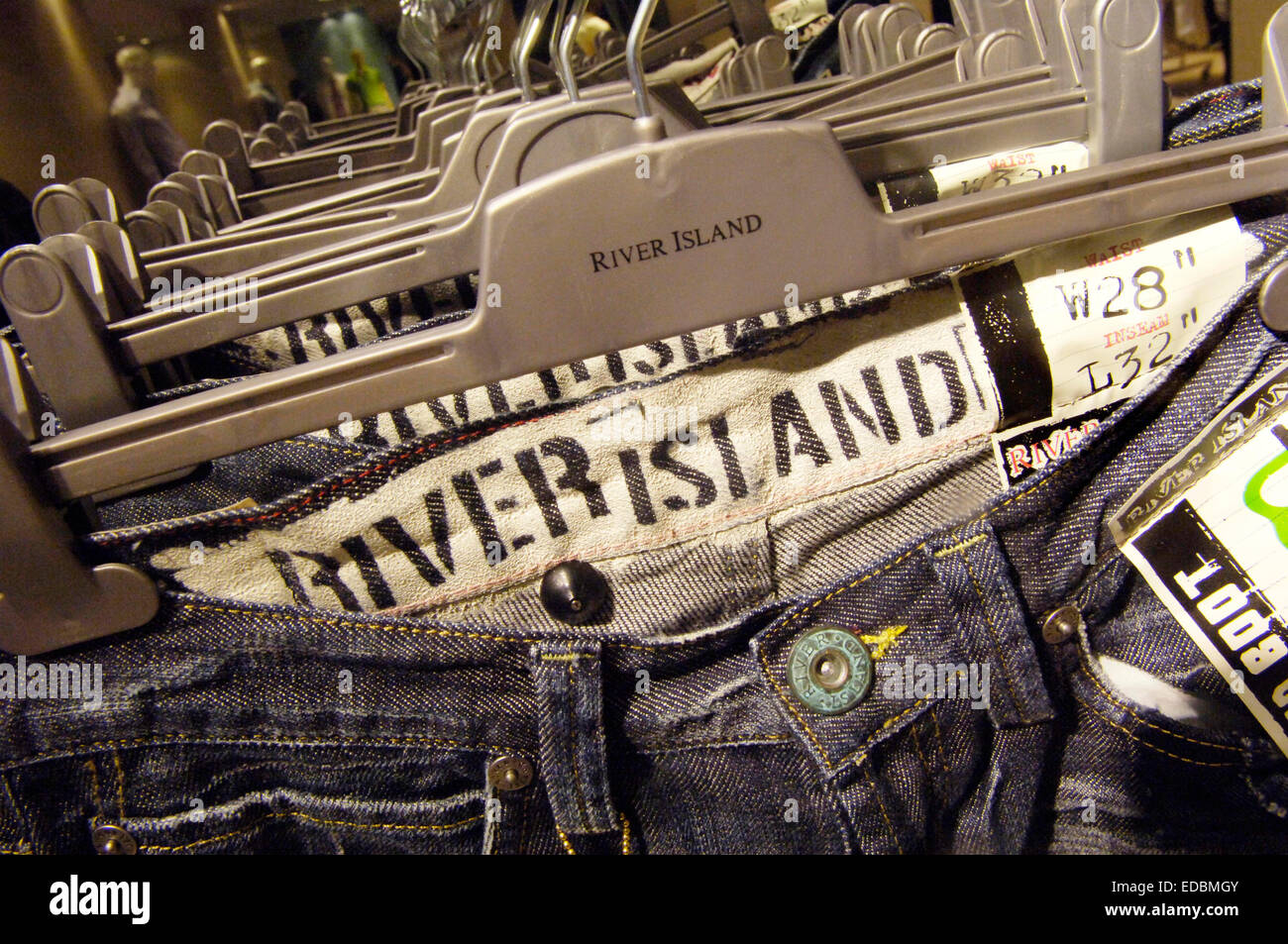 Jeans hanging, instore, River Island, London, England Stock Photo