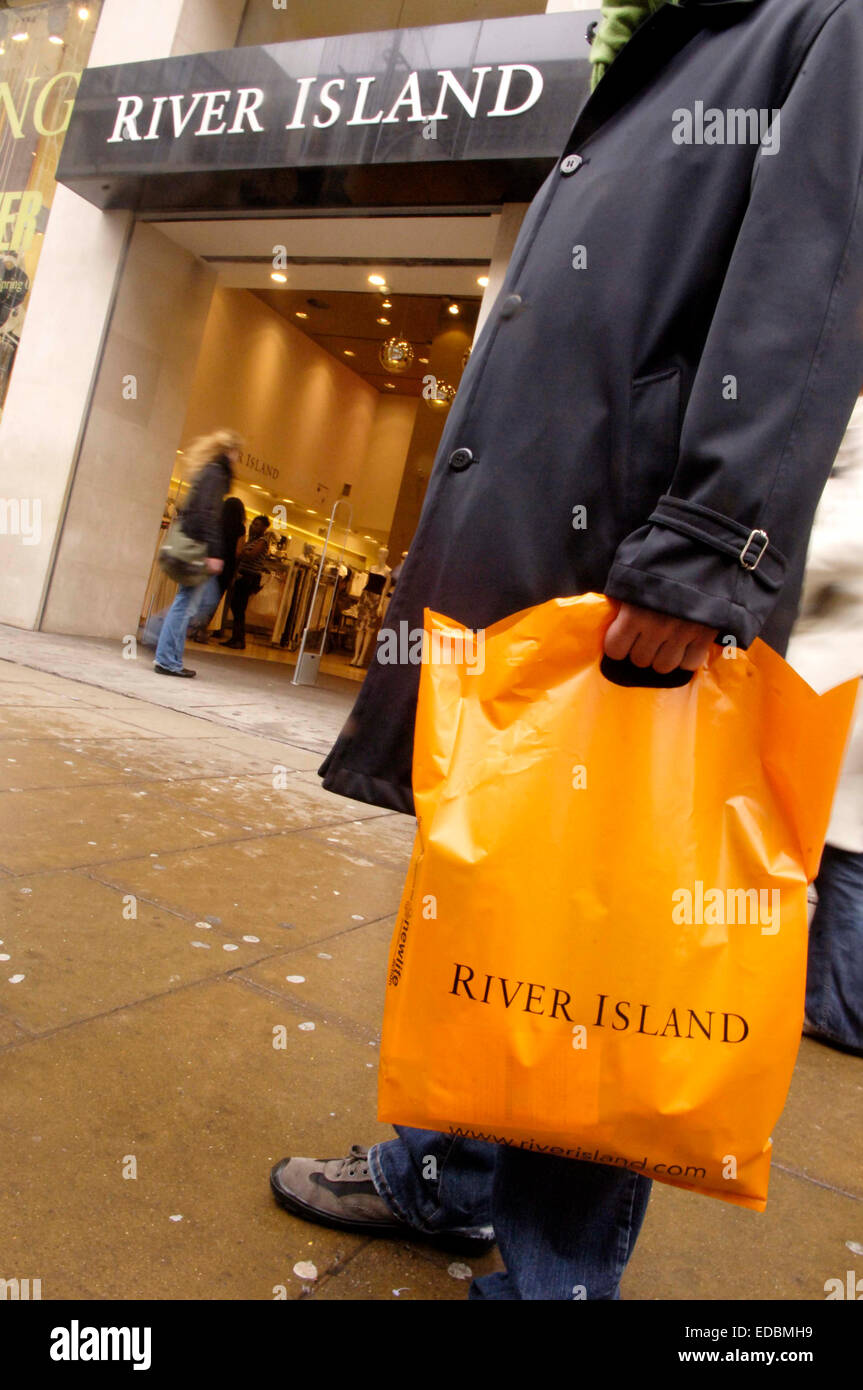 River Island shopper waiting outside a London store. Stock Photo