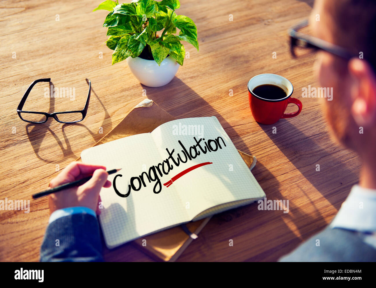 Man with a Note and a Single Word Congratulation Stock Photo