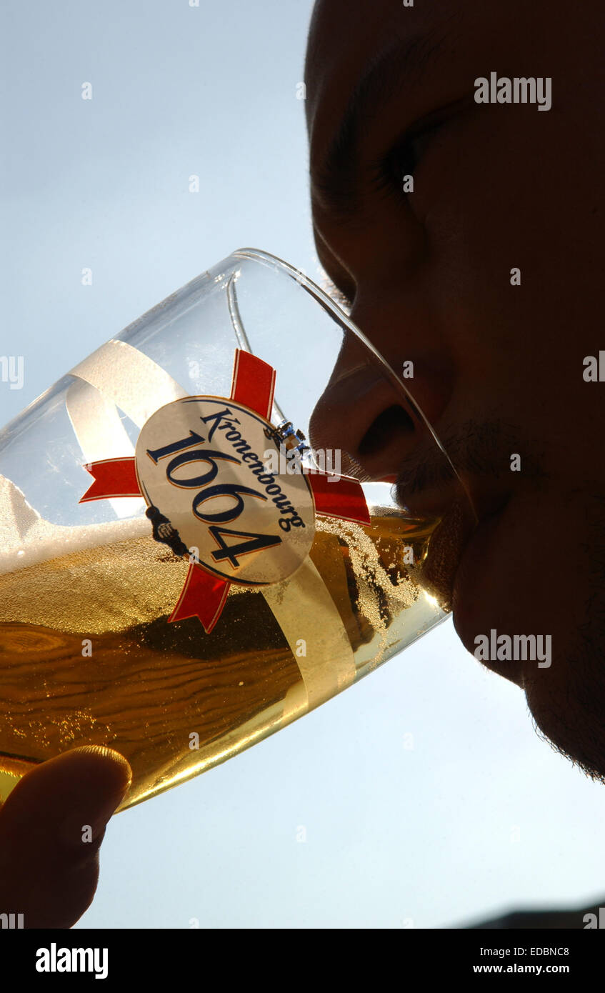 A man drinking Kronenbourg lager. Stock Photo