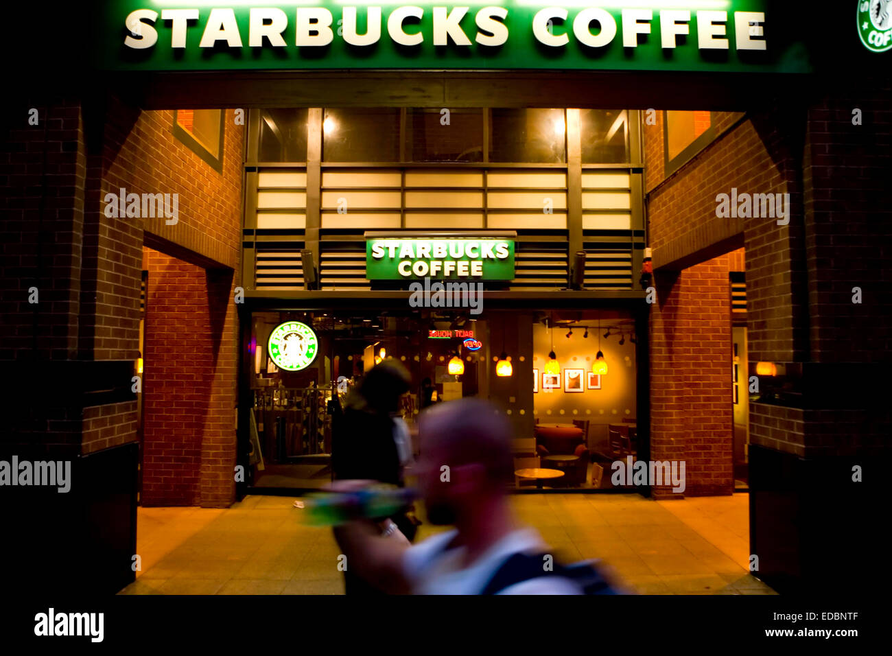 A Starbucks store in the evening. Stock Photo