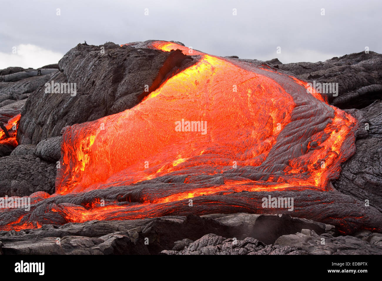 Glowing lava forming new land in Hawaii. Stock Photo