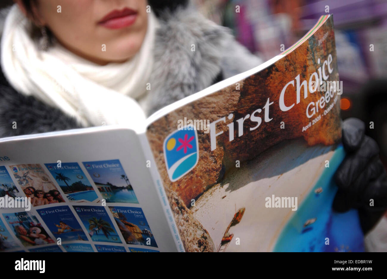 A woman browsing a First Choice holiday brochure. Stock Photo