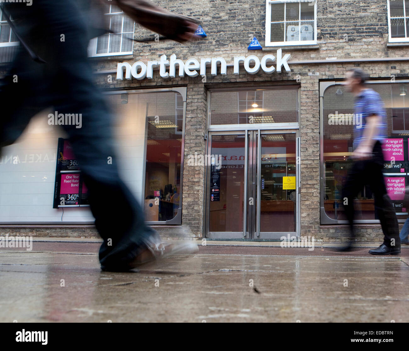 People pass in front of a branch of Northern Rock. Northern Rock today announced losses of £724.2 million in the first 6 months of 2009 compared with £585.4 million in the first half of 2008. 04/08/2009 Stock Photo
