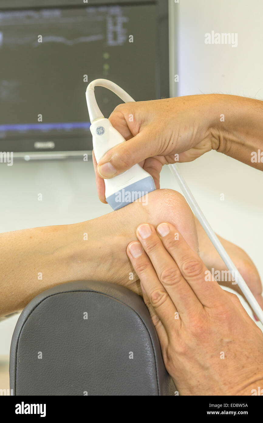 Foot echography on the heel with a screen in the background Stock Photo