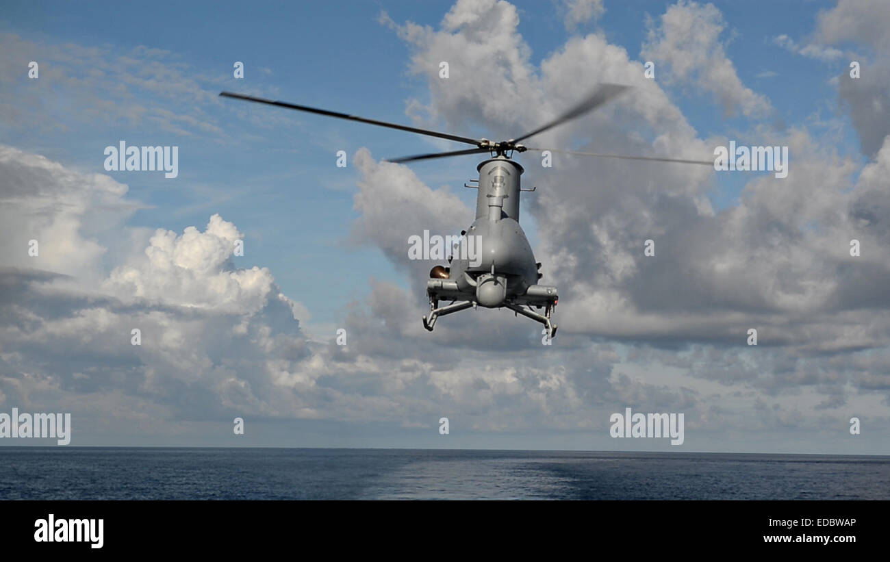 A US Navy MQ-8B Fire Scout unmanned helicopter prepares to land on the littoral combat ship USS Fort Worth during flight operations December 17, 2014 in the Pacific Ocean. Stock Photo