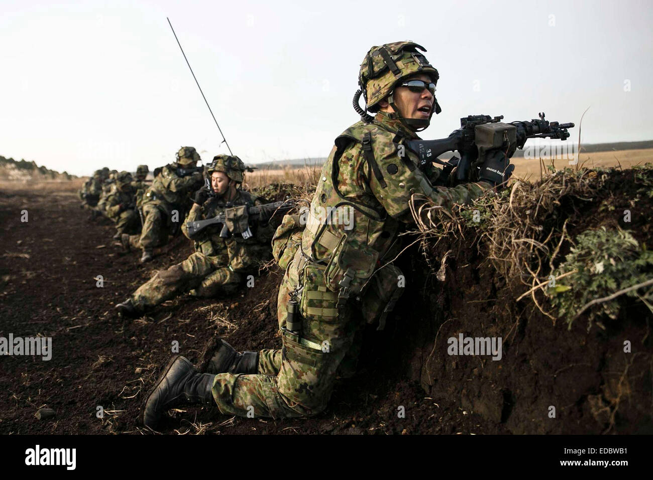 Japan Ground Self-Defense Force soldiers during a simulated firefight part of Forest Light joint training exercise at the Oyanohara Training Area December 9, 2014 in Yamato, Kumamoto prefecture, Japan. Stock Photo