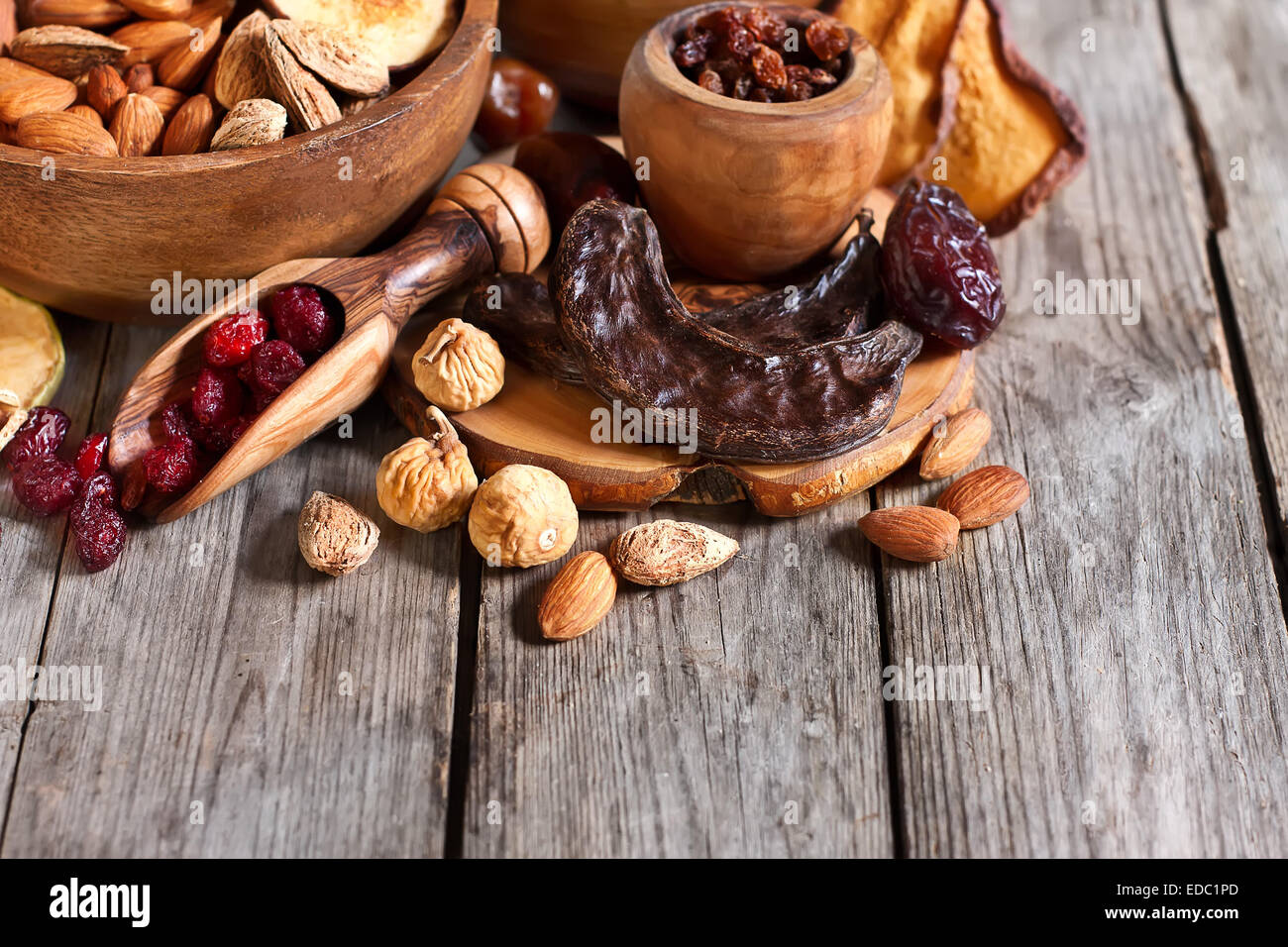 Mix of dried fruits and almonds - symbols of judaic holiday Tu Bishvat. Copyspace background. Stock Photo