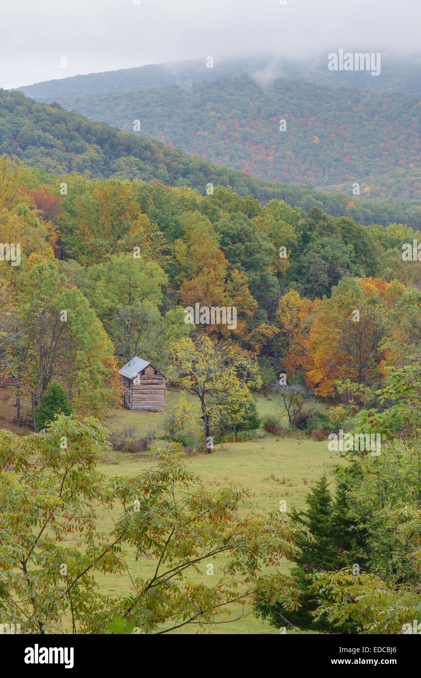 A small cabin sits in a lonely meadow in the Smoke Hole Region of West Virginia. Stock Photo