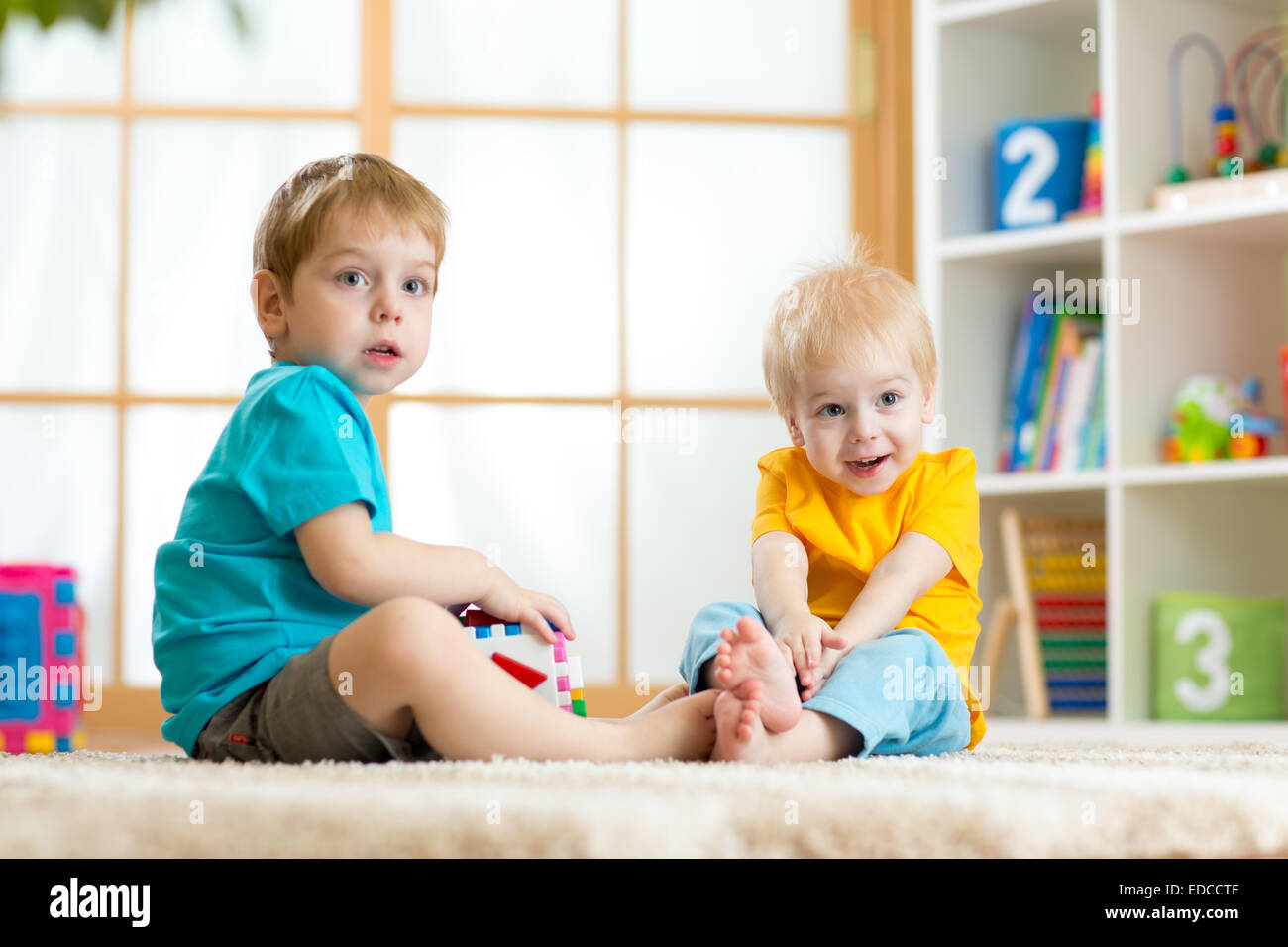 two little boys play together with educational toys Stock Photo
