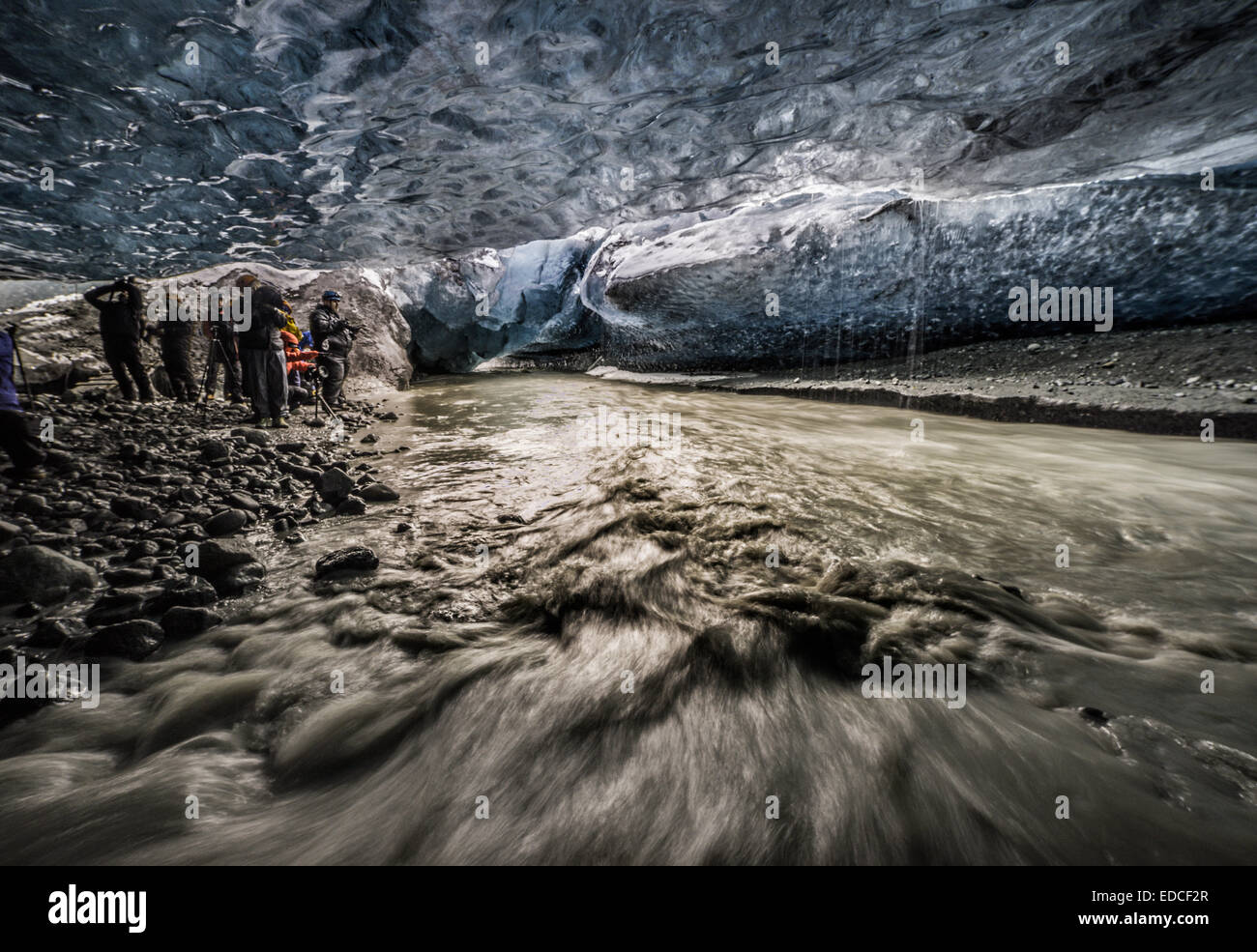 People exploring an ice cave, Breidamerkurjokull Glacier, Vatnajokull Ice Cap, Iceland Stock Photo
