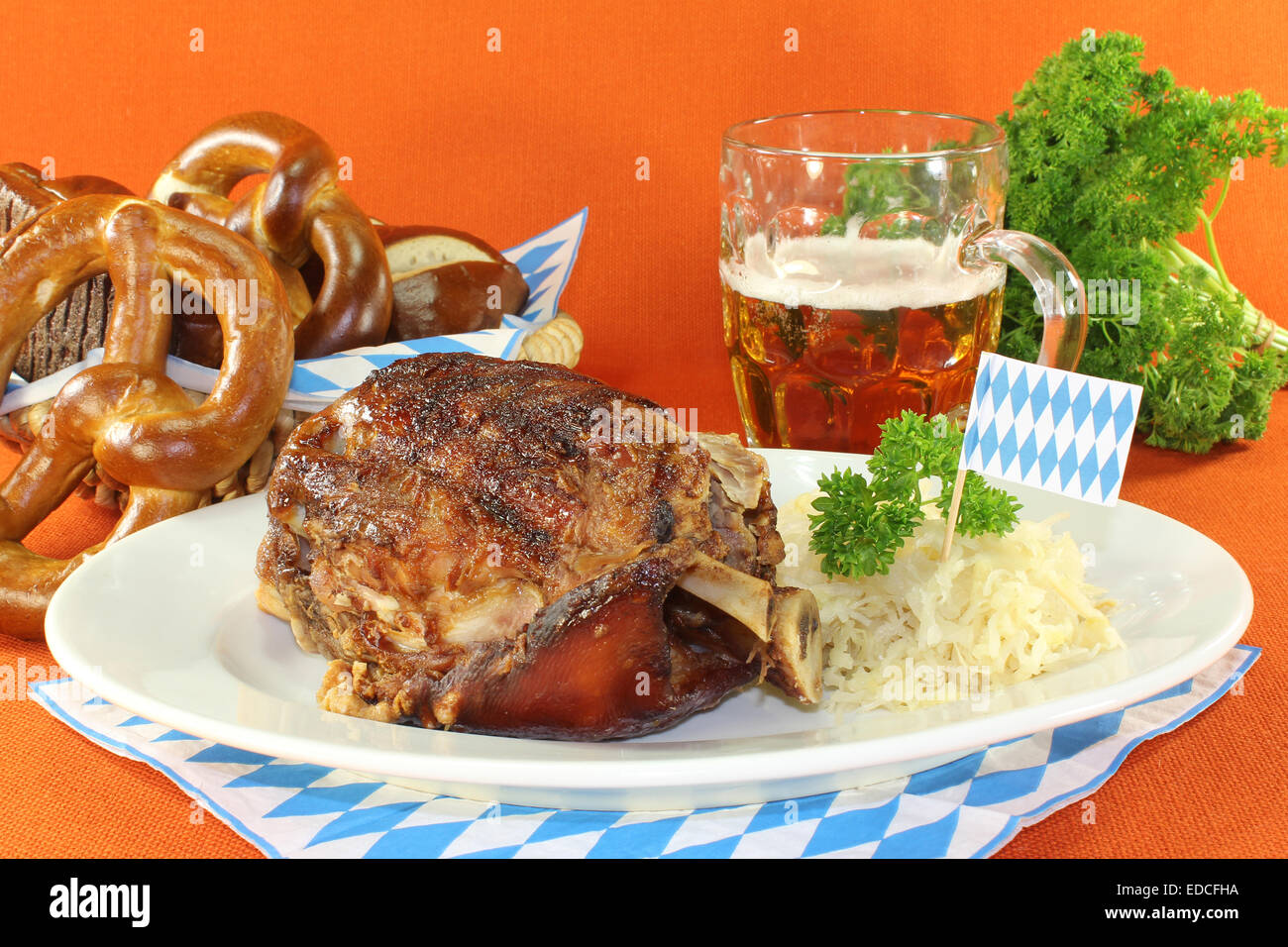 Pork knuckle with sauerkraut and pretzels Stock Photo