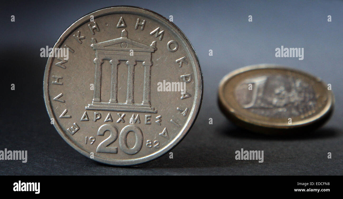 Wuerzburg, Germany. 03rd Nov, 2011. ILLUSTRATION - A Greek 20 drachm coin and a one-euro coin are pictured in Wuerzburg, Germany, 03 November 2011. After the controversial announcement to hold a referendum in Greece and massive international critique, the internal political conflict escalates: The future of Greek Prime Minister George Papandreou's government was in doubt as lawmakers from his governing Socialist party revolted against a referendum on whether the country wants to remain in the eurozone. Photo: Karl-Josef Hildenbrand/dpa/Alamy Live News Stock Photo