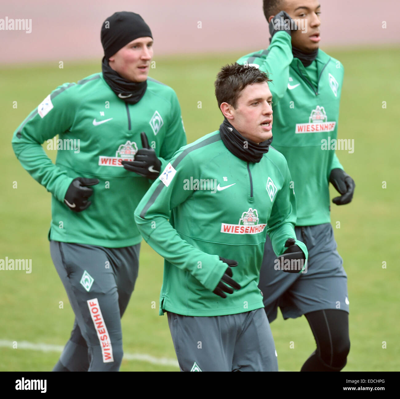 Werder's Izet Hajrovic (L-R), Zlatko Junuzovic and Melvyn Lorenzen run on field 11 near Weserstadion in Bremen, 5 January 2015. German Bundesliga soccer team Werder Bremen started its training. PHOTO: CARMEN JASPERSEN/DPA Stock Photo