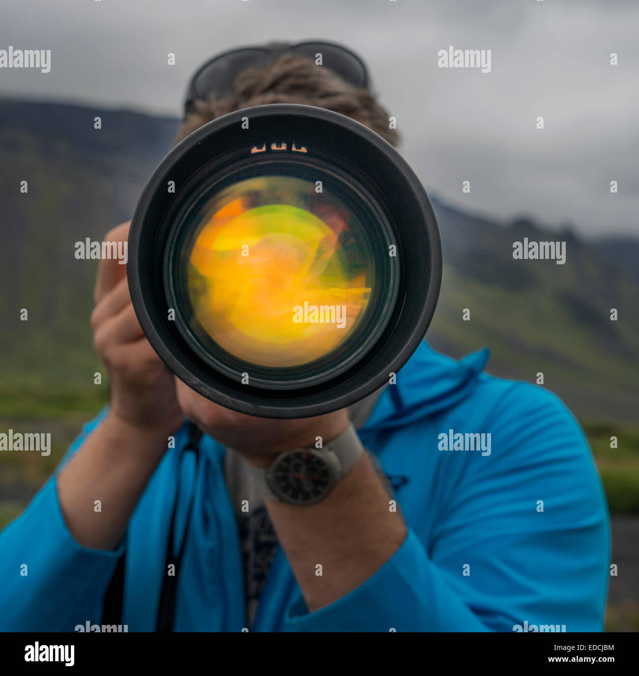 Photographer using a long lens to photograph near Seljalandsfoss Waterfall, South Coast, Iceland Stock Photo