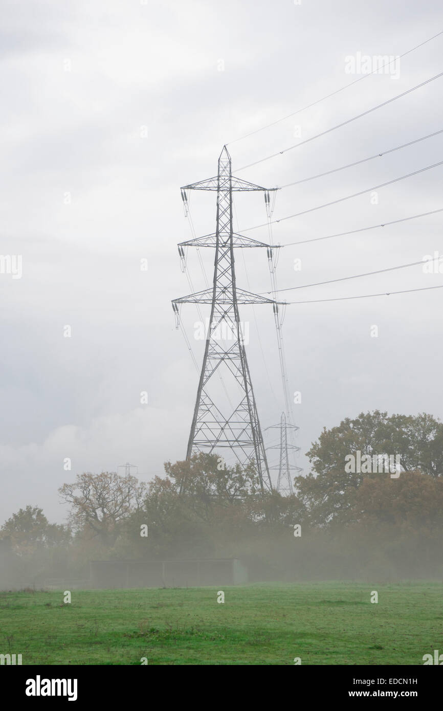 Transmission tower, pylon, in the foggy countryside Stock Photo