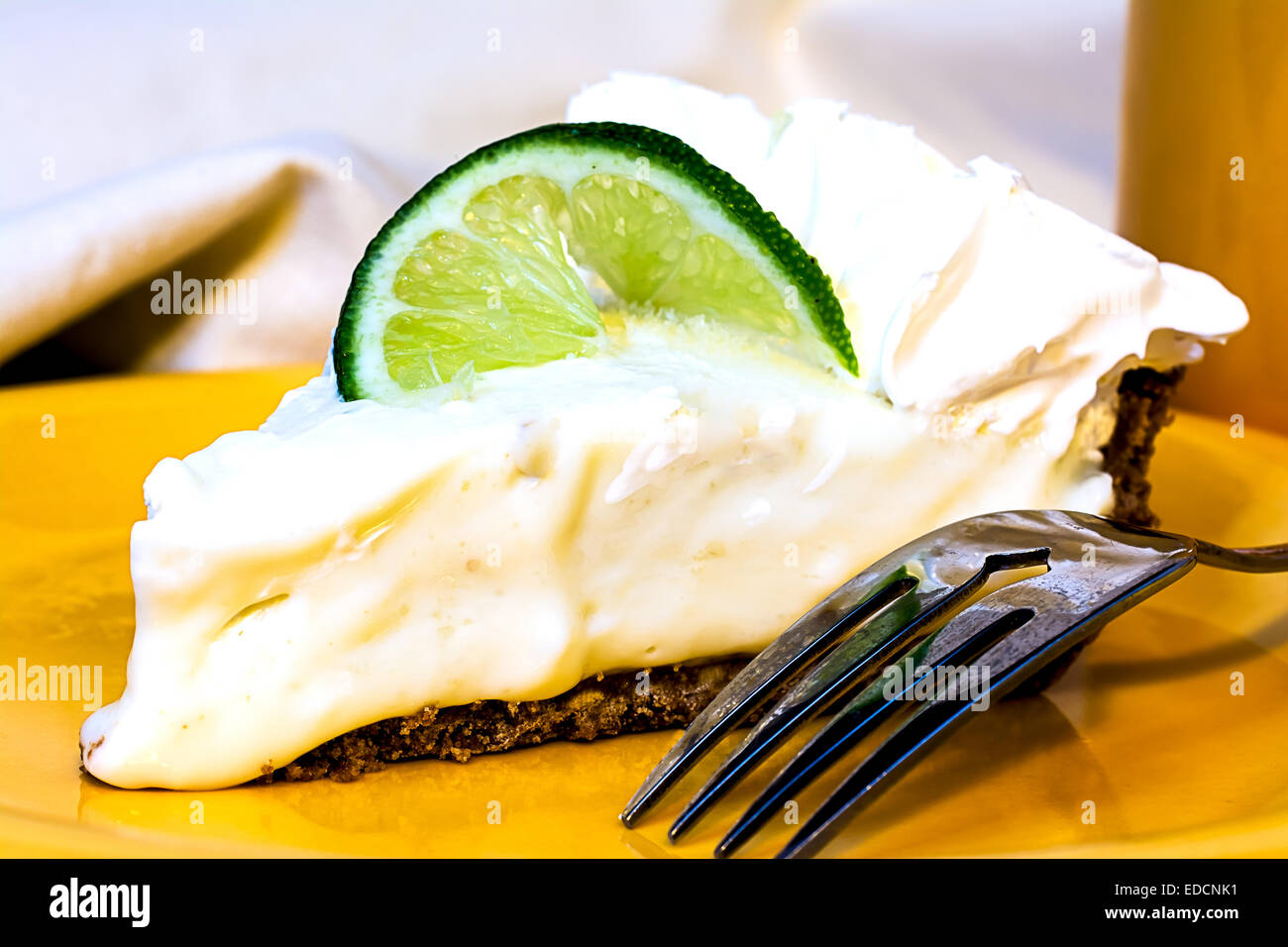Key lime pie closeup with fork on plate. Stock Photo