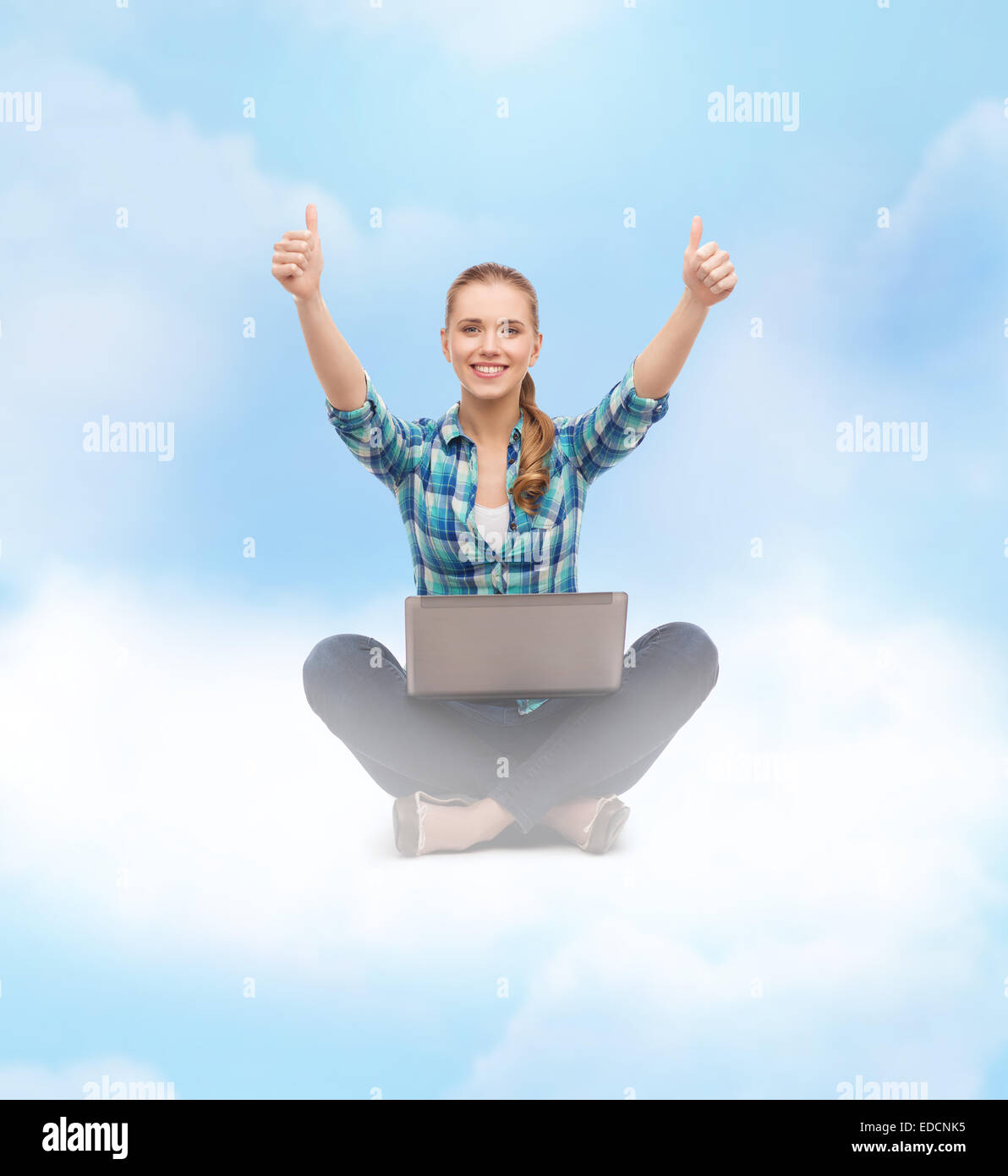 smiling woman with laptop and showing thumbs up Stock Photo - Alamy