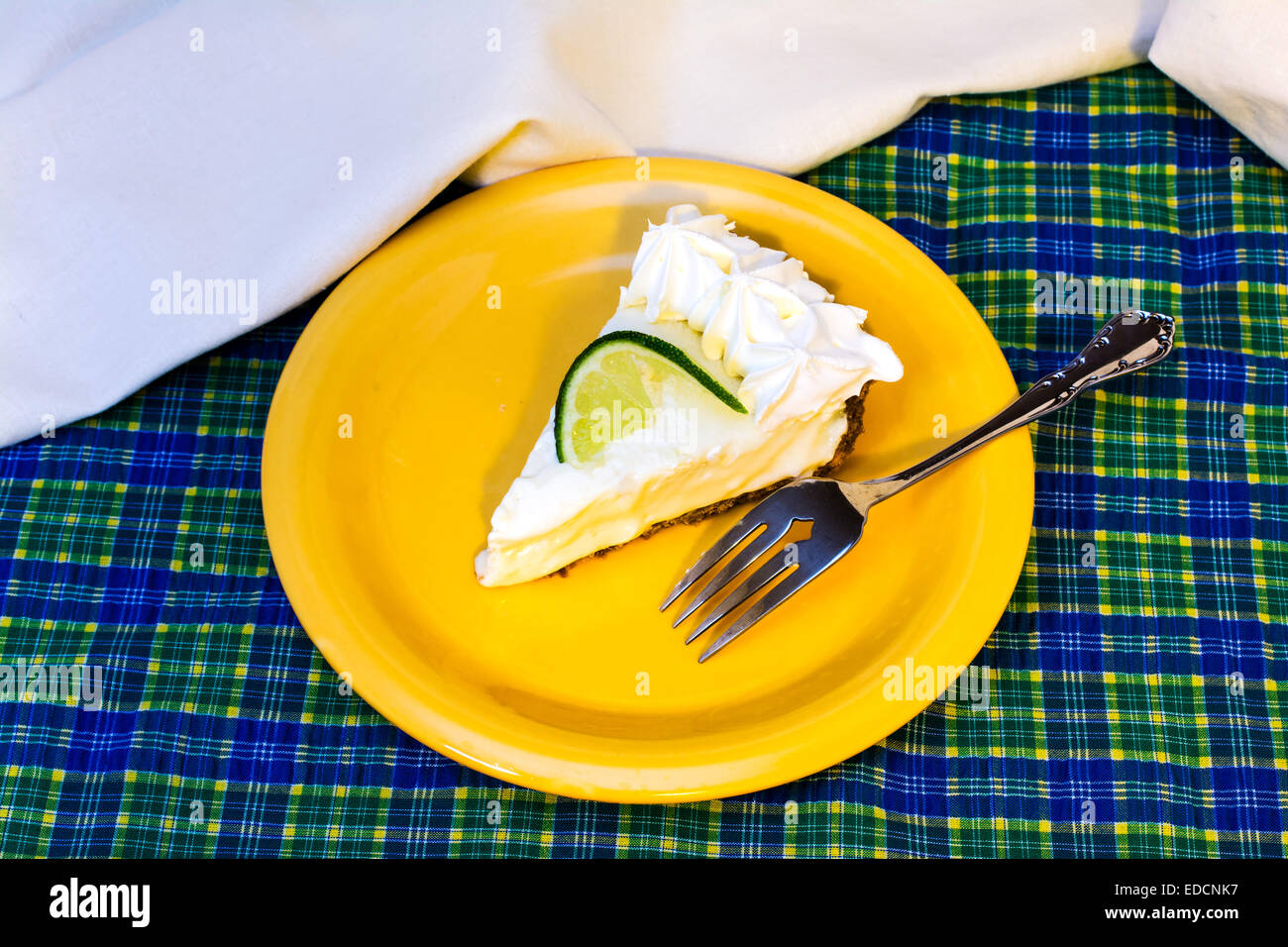 Slice of key lime pie with fork overhead. Stock Photo
