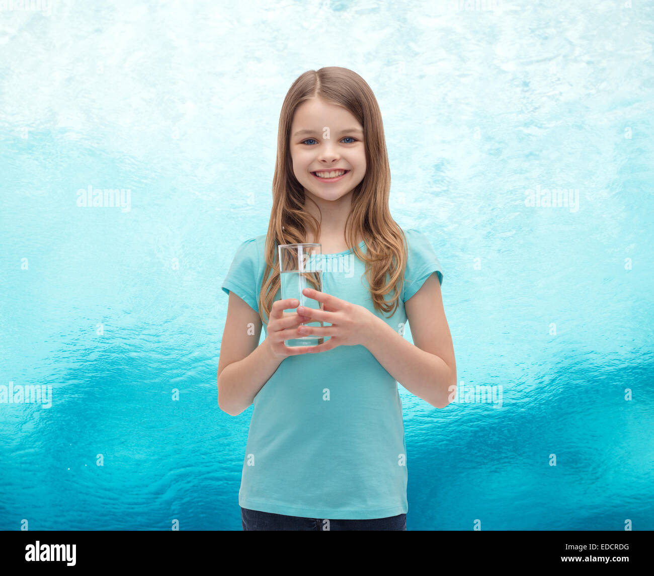 smiling little girl with glass of water Stock Photo - Alamy