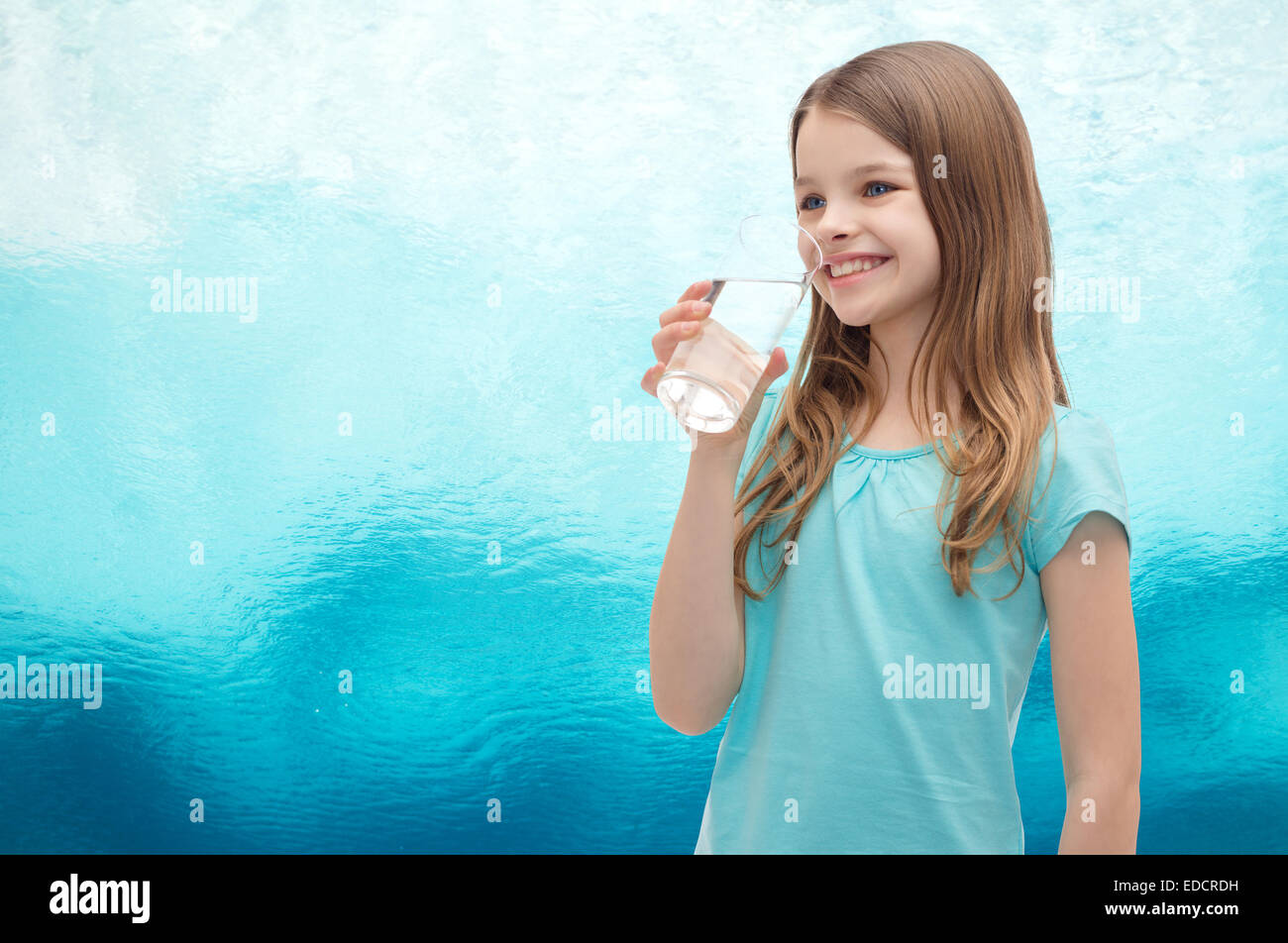 smiling little girl with glass of water Stock Photo - Alamy