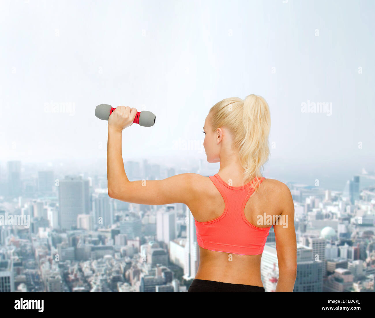 young sporty woman with light dumbbell Stock Photo