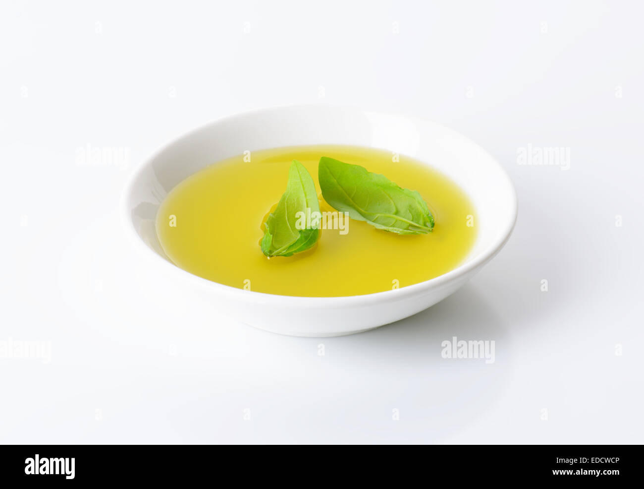 Olive oil in white porcelain bowl Stock Photo