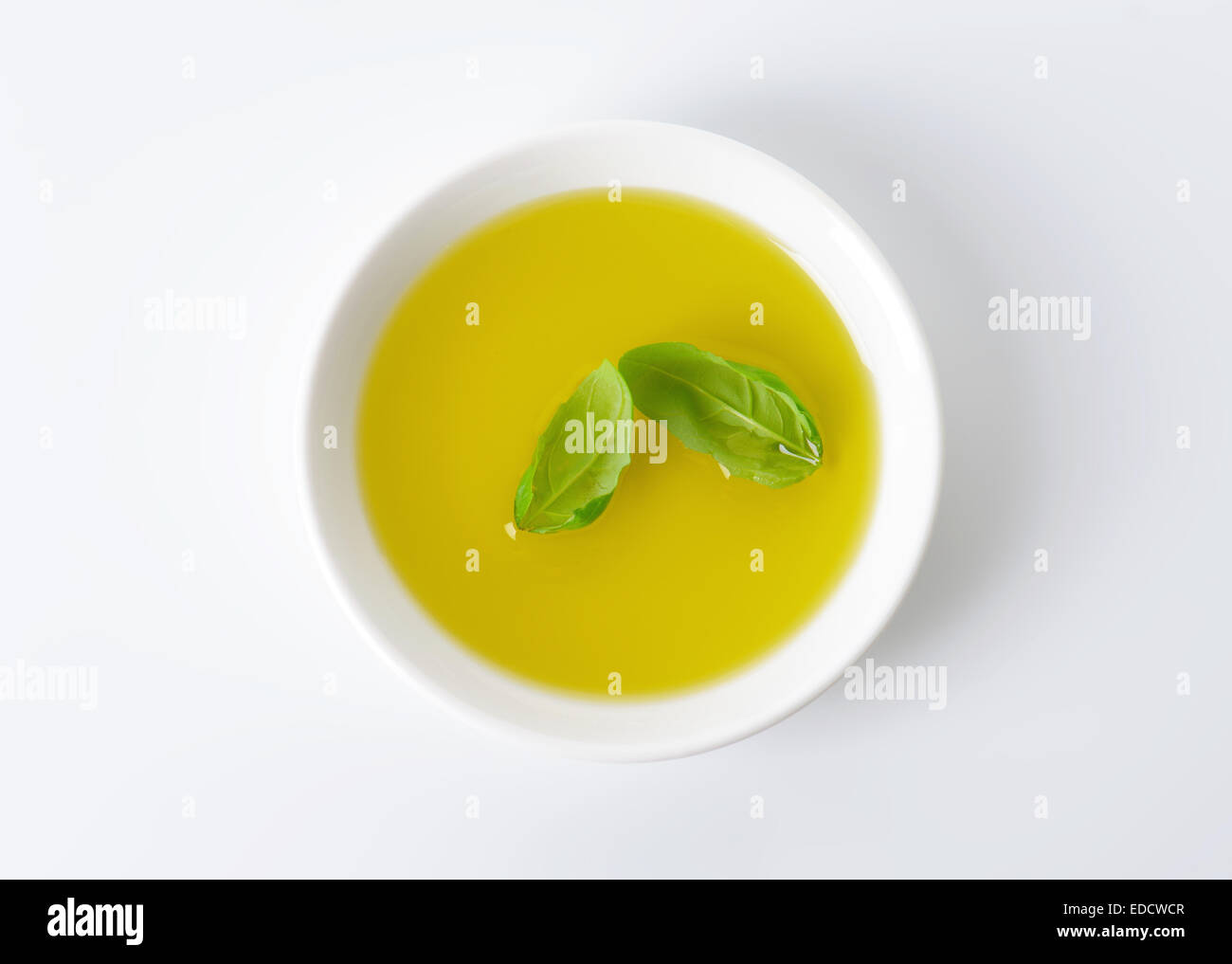 Olive oil in white porcelain bowl Stock Photo