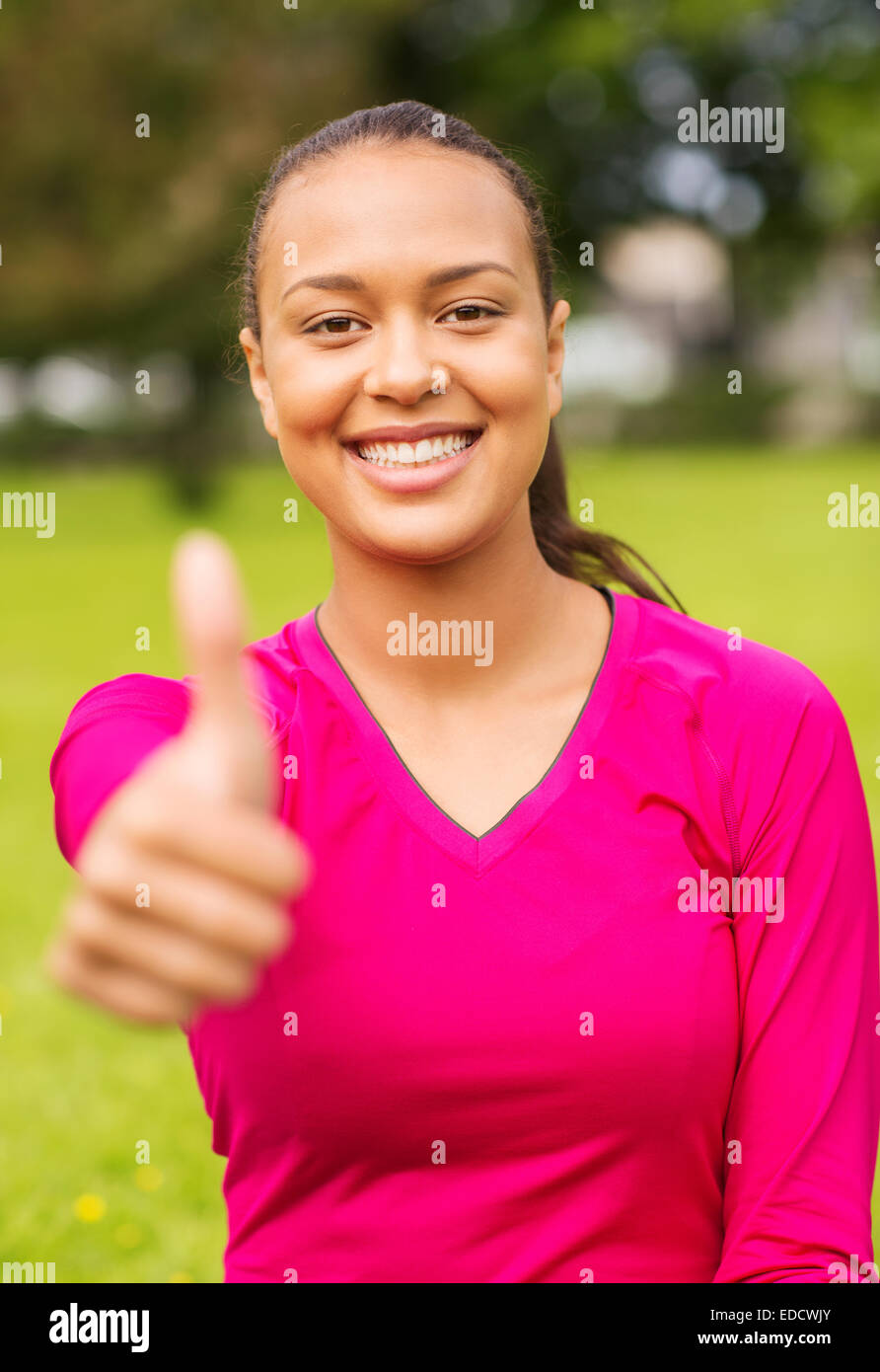 smiling african american woman showing thumbs up Stock Photo - Alamy