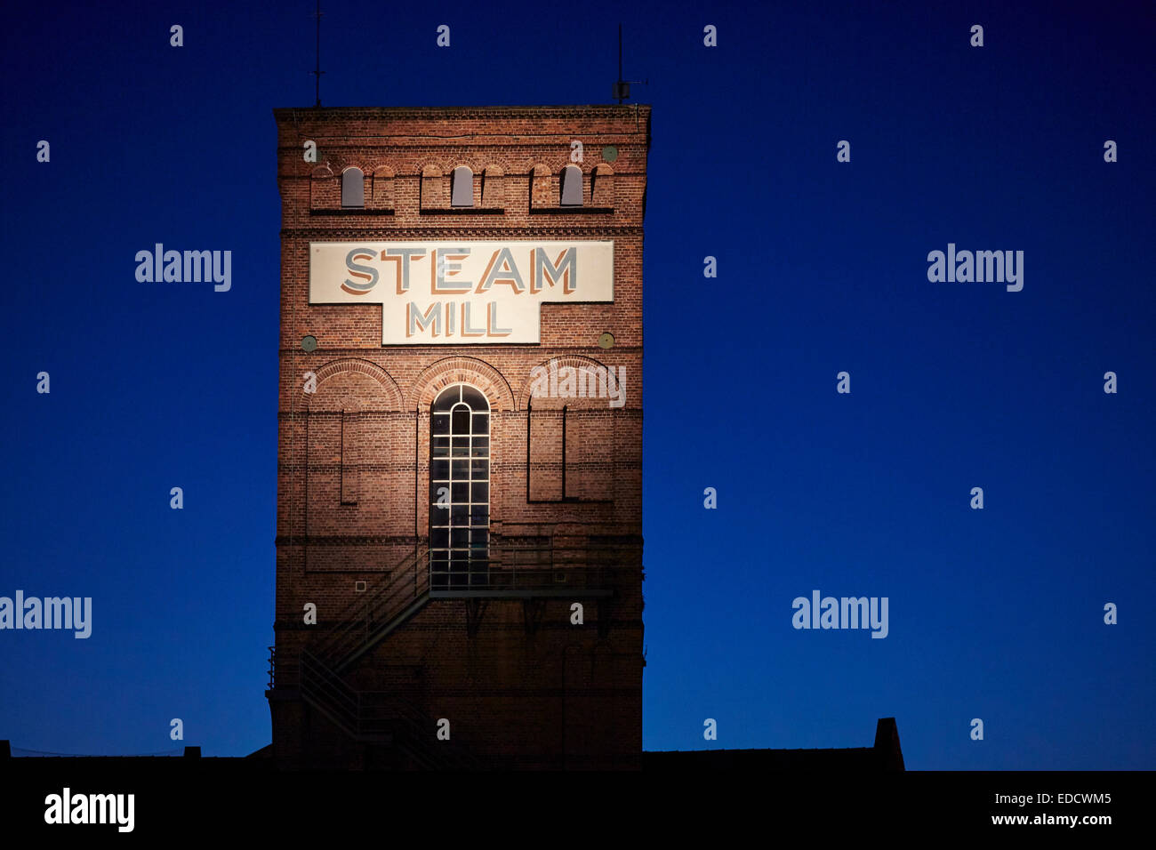 Brick built Steam Mill retail and offices in a victorian mill along the Shropshire Union Canal in Chester UK at sunset Stock Photo