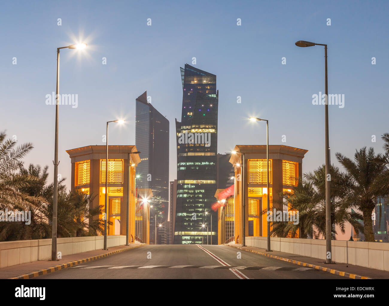 Architecture in Kuwait City illuminated at dusk Stock Photo