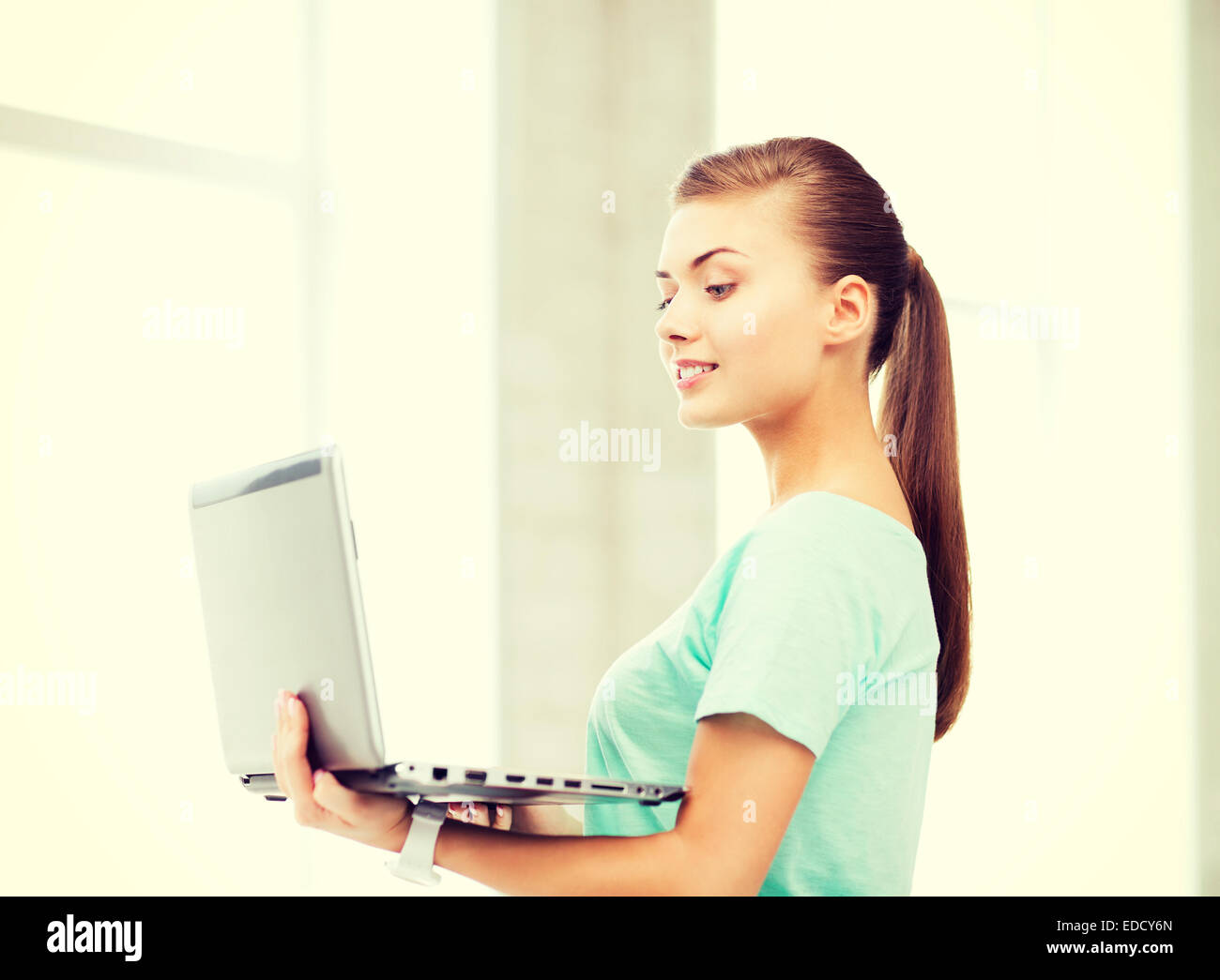 smiling student girl with laptop at school Stock Photo - Alamy