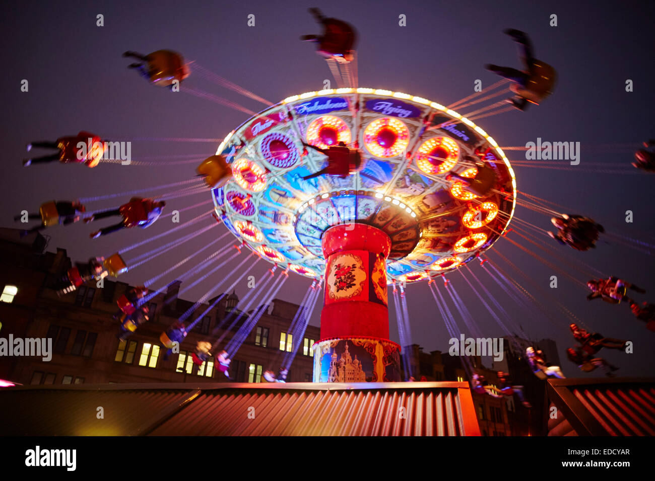 Manchester's German Christmas Markets, in the new location of Cathedral gardens  fairground ride Swing Ride Stock Photo