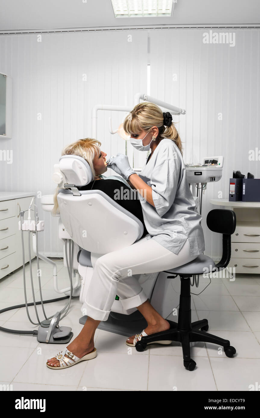dentist with patient, dental drilling Stock Photo Alamy