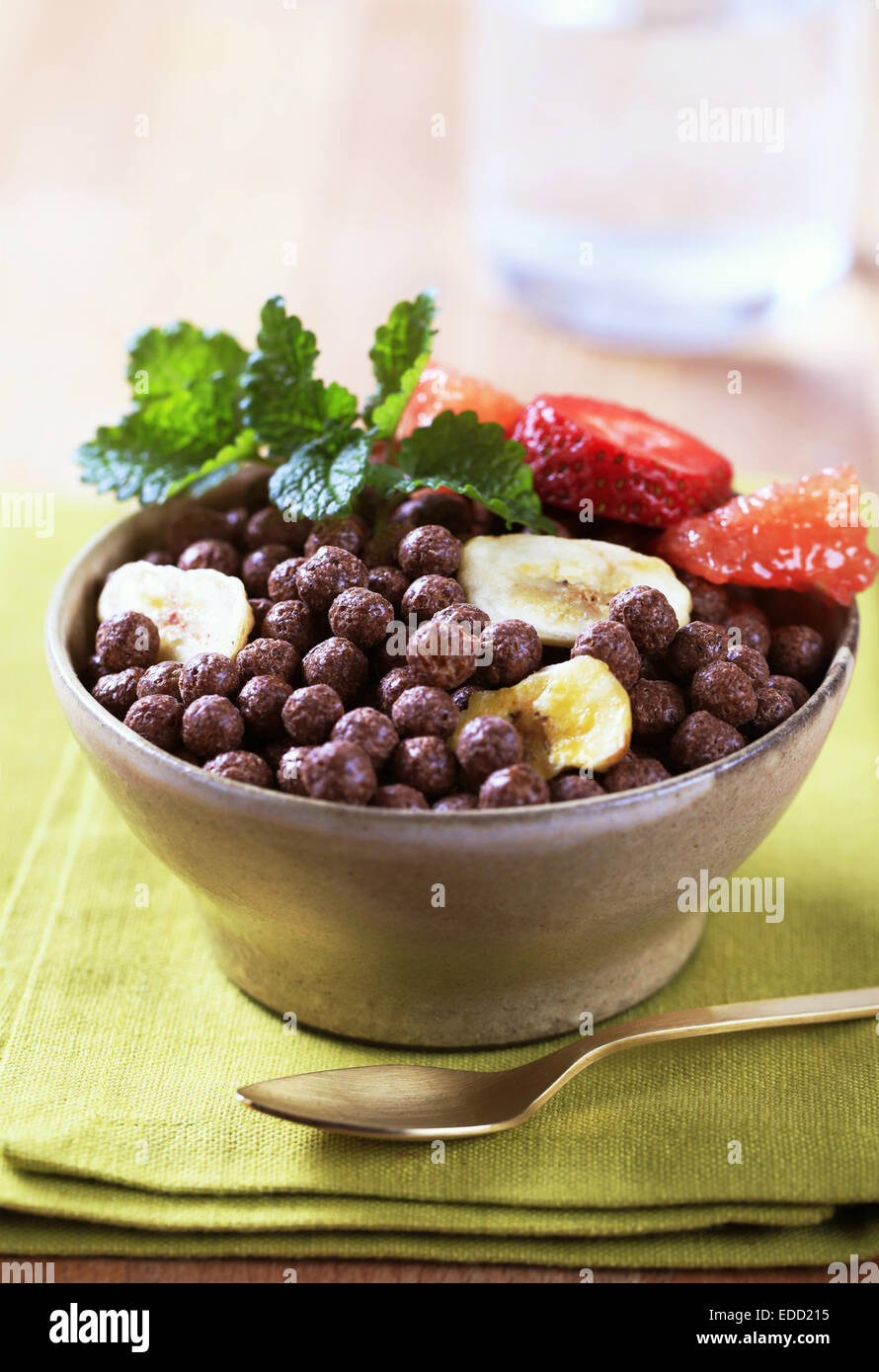 Bowl of cocoa-flavored puffs with fruit Stock Photo