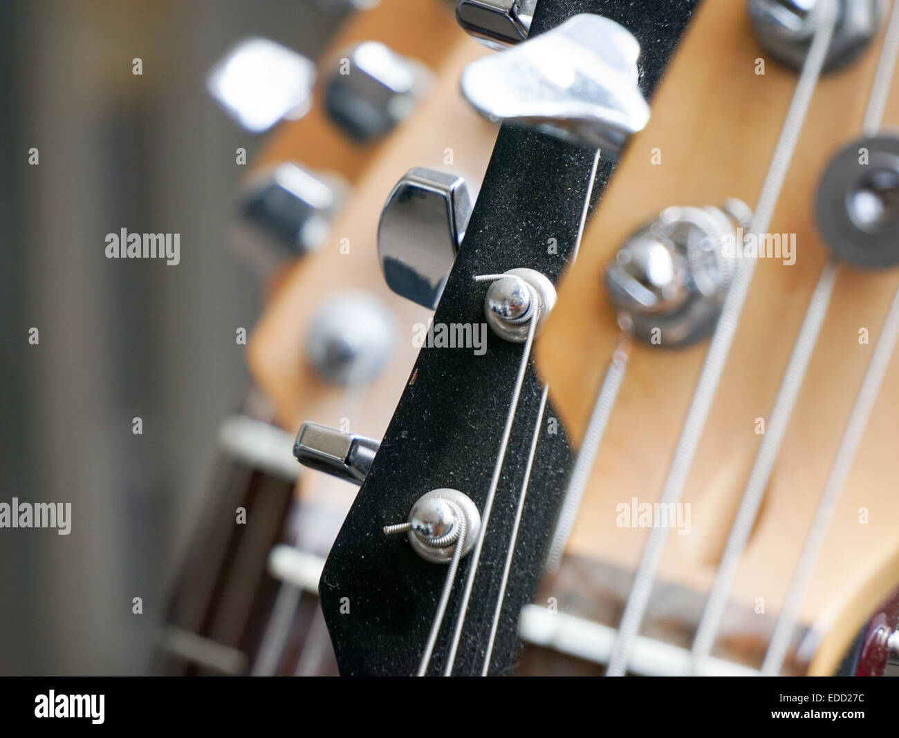Guitars on rack with bass and electric guitar Stock Photo
